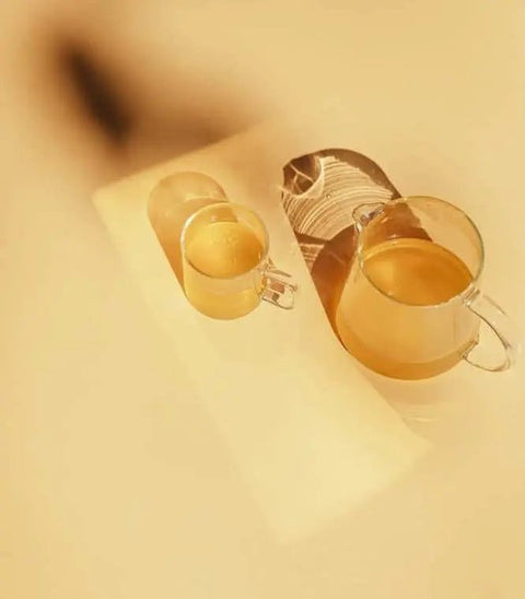 Two cups of tea on a table, symbolizing antioxidants in skincare