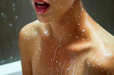 Close-up of woman’s chest with milk droplets, symbolizing nourishment with milk peptides