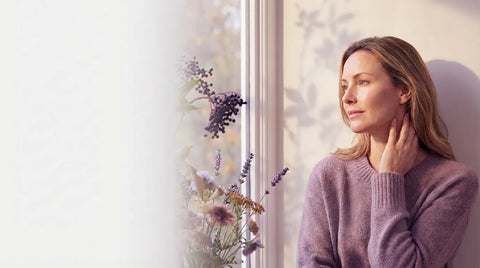 A blue gardening trowel used as a vase, holding an ikebana arrangement of green leaves, red and green flowers, encapsulating the essence of Brewing Beauty's Radiate skin care collection through its vibrant display.